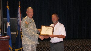 In October, Col. Michael J. Curry, USA (l), chapter president, presents an award for Special Service to Education to Richard Moch, former chapter vice president for education.